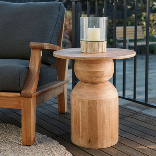 Stylish CG Hunter Handmade Natural Wooden Accent Table styled outdoors with a candle and chair, demonstrating its versatility and elegance in any setting.