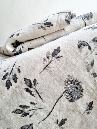 Luxurious floral tablecloth featuring a grey hydrangea print, crafted from 100% linen by CG Hunter, showcasing exquisite texture and detail.