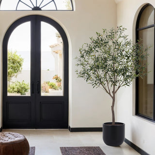 CG Hunter 6.5' Faux Potted Olive Tree elegantly positioned in a beautifully lit entryway, adding a touch of sophistication to luxury interior design.