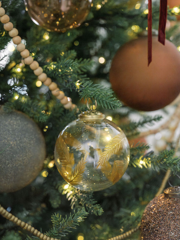 4" Handblown Gold Etched Glass Ornament on a timeless holiday tree