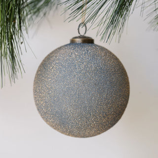 Luxury 5" Textured Slate Blue Glass Ornament by CG Hunter, showcasing intricate sparkle on a natural background.