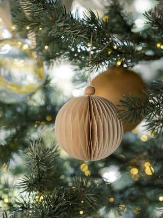 Stylish paper ornament by CG Hunter, beautifully adorned in a Christmas tree setting, enhancing the festive atmosphere with its refined design.
