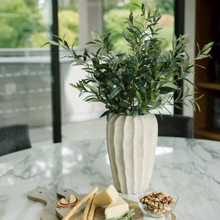 chic 30" Faux Olive Arrangement in Artisan Vase by CG Hunter, set on a marble table with cheese and snacks, harmonizing natural beauty and elegance in a luxurious home setting.