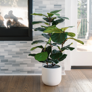 Elegant 3' Faux Potted Fiddle Leaf Fig Tree by CG Hunter, beautifully styled next to a fireplace, enhancing modern interiors with its vibrant foliage.