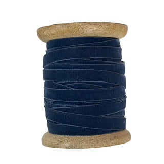 Artisan-crafted Narrow Hand Dyed Velvet Ribbon in Dark Blue by CG Hunter, presented on a stylish wooden spool, exuding sophistication and charm for festive occasions.