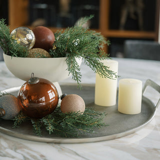 Elegant display featuring CG Hunter's 20" Faux Evergreen Cedar Branch arranged with holiday ornaments and candles, perfect for luxurious seasonal decor.