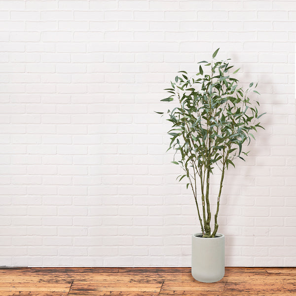 CG Hunter Artificial Willow Eucalyptus Tree 7' with Artisan Planter on white brick wall