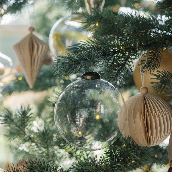Clear Glass ornament mixed with handcut paper ornaments on tree