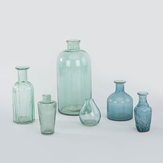 Elegant assortment of handcrafted blue and green glass bud vases by CG Hunter, showcasing unique shapes and soothing hues, ideal for stylish decor.