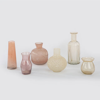 Elegant assortment of yellow and peach glass bud vases by CG Hunter, showcasing a variety of shapes and textures for luxurious home decor.
