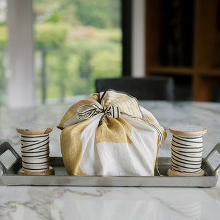 Exquisite arrangement of handmade wooden spools of Grosgrain Ribbon in Cream and Black by CG Hunter, enhancing the aesthetic of beautifully wrapped gifts.