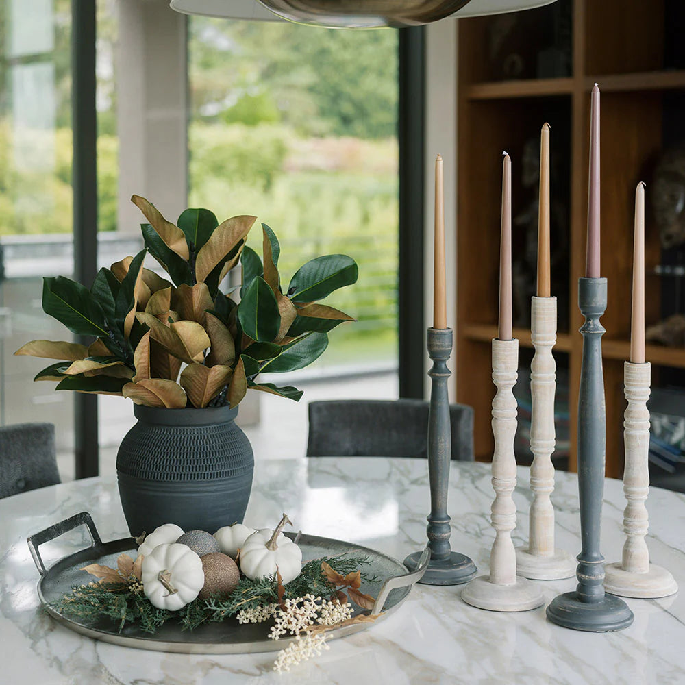 Black Terracotta 11" Vase with Magnolia Stems next to Wooden Candleholders