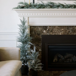 Stunning flocked trees near a fireside make a cozy christmas holiday gift