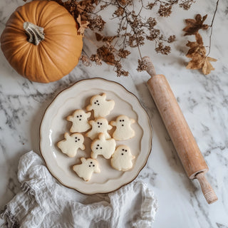 Gifts for the Baker collection featuring a plate of ghost-shaped cookies, a vintage rolling pin, and a charming pumpkin, perfect for celebrating the art of baking. Ideal gifts for bakers.