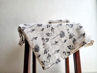 Elegant CG Hunter handcrafted linen tablecloth featuring a delicate floral design, perfect for refined table settings and sophisticated dining experiences.