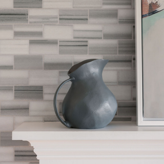CG Hunter 8.5" Warm Grey Aluminum Vase with Handle, showcasing a chic warm grey finish, displayed elegantly on a mantel against a stylish backdrop.