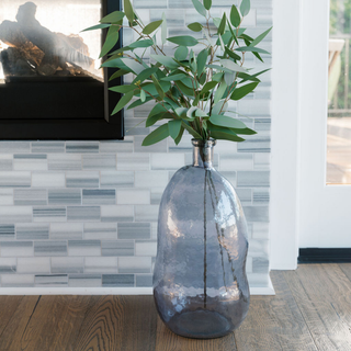 Chic CG Hunter Hammered Glass Vase in Smoke placed near a stylish fireplace, accentuating the home decor with its distinct hammered finish and modern aesthetic.