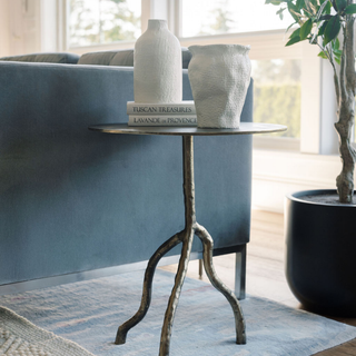 Chic CG Hunter Handcrafted Antique Brass Aluminum Accent Table complemented by decorative vases, creating a luxurious ambiance in a modern living space.