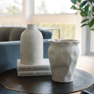 Stylish CG Hunter Off-White Aluminum Textured Vase alongside a complementary piece, enhancing a chic living room setting.