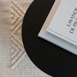 Top view of a modern table book placed on a CG Hunter Natural Sisal & Wool Diamond Loop Rug, featuring its soft and sophisticated design.