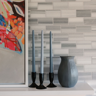 Stylish display of CG Hunter's 3.5" Iron Candleholders in Black featuring taper candles, accentuating a contemporary living space with artistic decor elements.