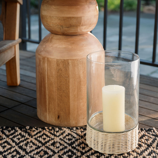 Outdoor setting with CG Hunter Natural and Black Diamonds Jute Rug underneath a glass candle holder, adding an upscale touch to the space.