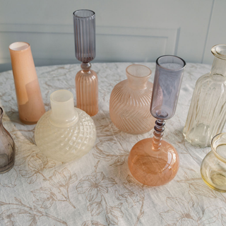 Artistic arrangement of CG Hunter Etched Borosilicate Glass Bud Vases in Smoke on a light-colored tablecloth, perfect for enhancing luxury home decor.