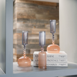 Stylish arrangement of CG Hunter Etched Borosilicate Glass Bud Vases in Smoke displayed on books in a chic environment, highlighting their refined craftsmanship and versatility for home decor.