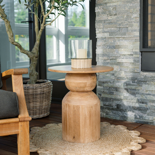 CG Hunter Handcrafted Clear Glass and Rattan Candleholder gracing a chic wooden table in a beautifully designed space, enhancing the decor with its luxurious charm.