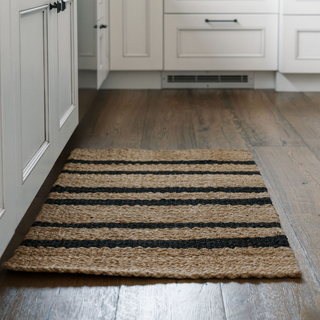 Luxurious CG Hunter Handmade Natural and Black Striped Jute Rug placed elegantly in a modern kitchen setting, showcasing its beautiful texture and classic design.