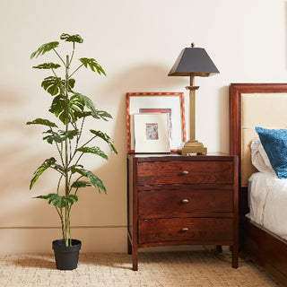 Contemporary 5' Artificial Monstera Tree by CG Hunter placed in a minimalist black pot, showcasing luxury and elegance in a well-appointed bedroom.