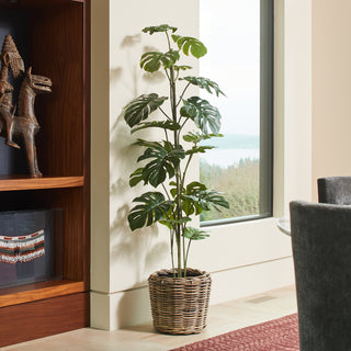Elegant 5' Artificial Monstera Tree by CG Hunter displayed in a stylish living room corner with a scenic view, adding a touch of luxury to modern home decor.