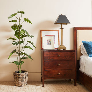 Chic 5' Artificial Monstera Tree by CG Hunter paired with a rustic woven pot, creating a modern yet inviting atmosphere in a stylish bedroom setting.