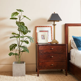 Luxurious 5' Artificial Monstera Tree by CG Hunter displayed elegantly in a modern living space, beside a stylish lamp and framed artwork.