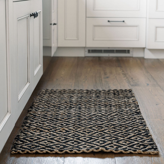 Spacious kitchen featuring the CG Hunter Natural and Black Diamonds Jute Rug, showcasing its elegant design on a rich wooden floor.
