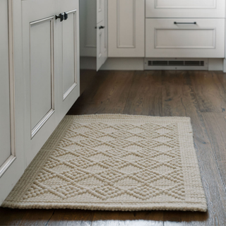 Luxurious CG Hunter Handmade Natural Sisal & Wool Diamond Loop Rug showcased in a kitchen setting, featuring an elegant diamond loop pattern on a soft cream backdrop, enhancing the warm and inviting atmosphere of the space.