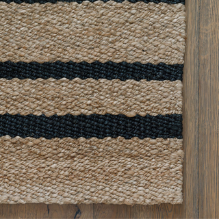 Detailed close-up of the texture of the CG Hunter Handmade Natural and Black Striped Jute Rug, emphasizing its luxurious craftsmanship and sustainable jute material.