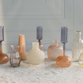 Charming collection of CG Hunter Etched Borosilicate Glass Bud Vases in Smoke, showcasing a variety of shapes and sizes on a stylish table setting.