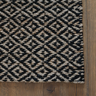 Close-up of CG Hunter Natural and Black Diamonds Jute Rug, highlighting the intricate braided pattern and luxurious texture.