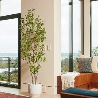 Elegant 7' Artificial Heart Ficus Tree by CG Hunter, beautifully displayed in a modern interior setting with large windows, adding a touch of nature to luxurious home decor.