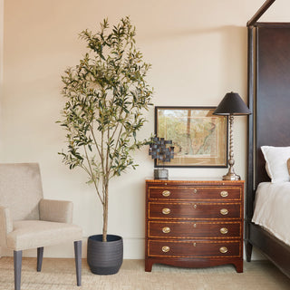 Luxurious 7' Artificial Wispy Olive Tree by CG Hunter, elegantly placed in a modern bedroom setting, enhancing the decor with its natural beauty and style.