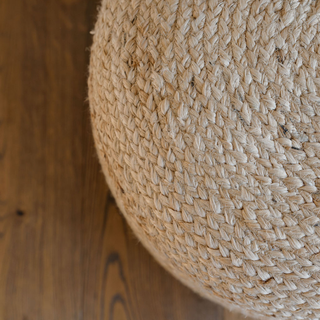 Close-up view of the CG Hunter Round Braided Jute Ottoman Pouf, highlighting the intricate braided detail and earthy tones of natural jute, perfect for luxurious home decor.