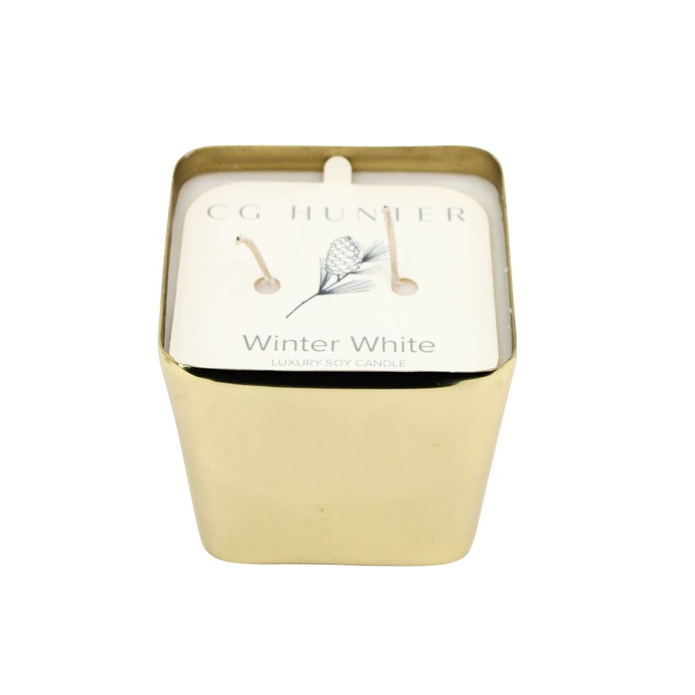CG Hunter Winter White Candle in a luxurious gold container, showcasing an elegant design perfect for holiday decor.