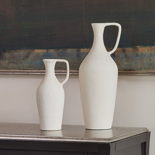 Close up of matching creme pitchers