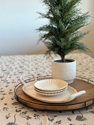 Stylish dining table setting featuring a CG Hunter cedar tree in a chic pot, accompanied by elegant dishware for a refined dining experience.