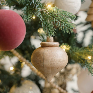 Luxurious 5" Wooden Finial Christmas Ornament hanging gracefully on a decorated tree by CG Hunter, made from exquisite mango wood for rustic charm.