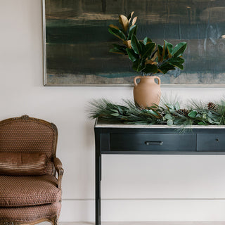 Elegant 12" Terracotta Vase with Handles by CG Hunter, showcasing rustic charm on a sleek black table, surrounded by vivid greenery and art, perfect for luxurious home settings.