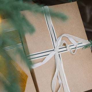 Grosgrain Ribbon in Cream and Black 10 Yards Per Spool by CG Hunter delicately securing a simple yet elegant gift box, showcasing a sophisticated style for special occasions.