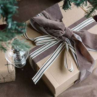 Luxurious wrapped gift featuring the Brown and Gray Striped Ribbon by CG Hunter, artfully tied with a chic bow, perfect for enhancing your home decor.