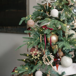 Festively decorated Christmas tree with a variety of luxurious ornaments, including beaded pieces from CG Hunter's Beaded Snowflake and Star Christmas Ornaments collection.